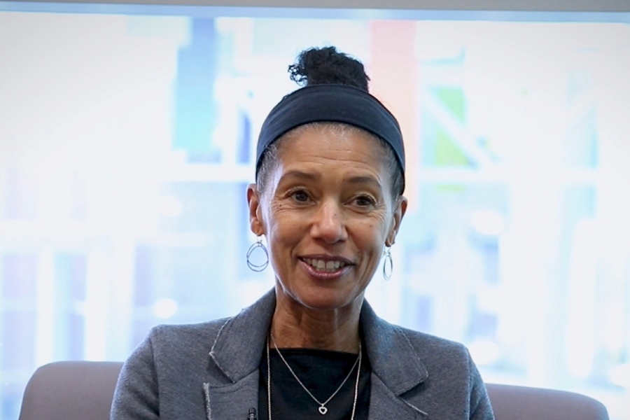 Dr. Delia Douglas smiling while looking away from the camera.