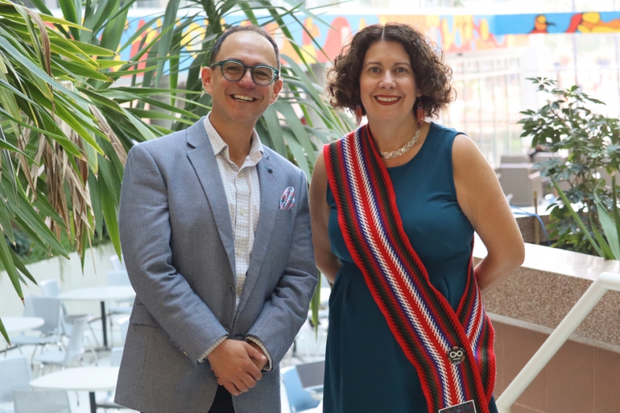 Dr. Michelle Driedger and Dr. Nathan Nickel pose for a photo. Driedger is  wearing a Métis sash.