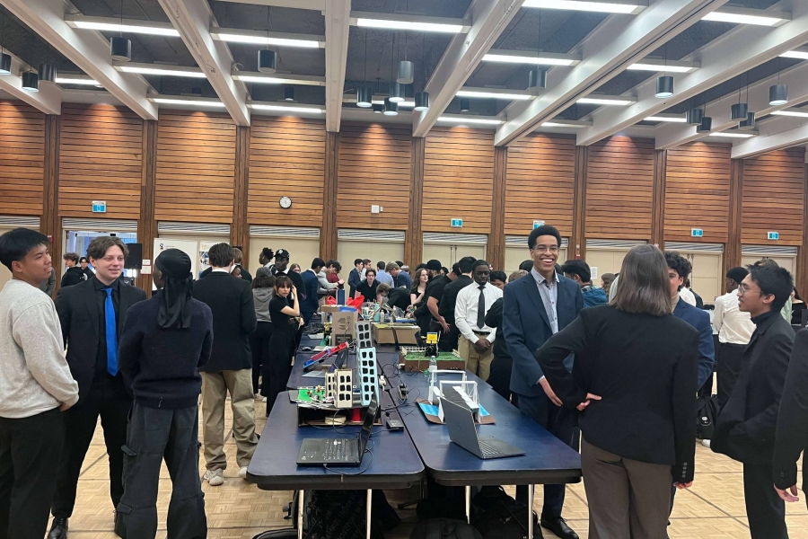 prototypes set up on tables surrounded by students