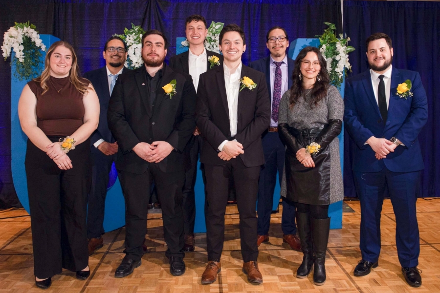 A group of people in formal wear looking at camera