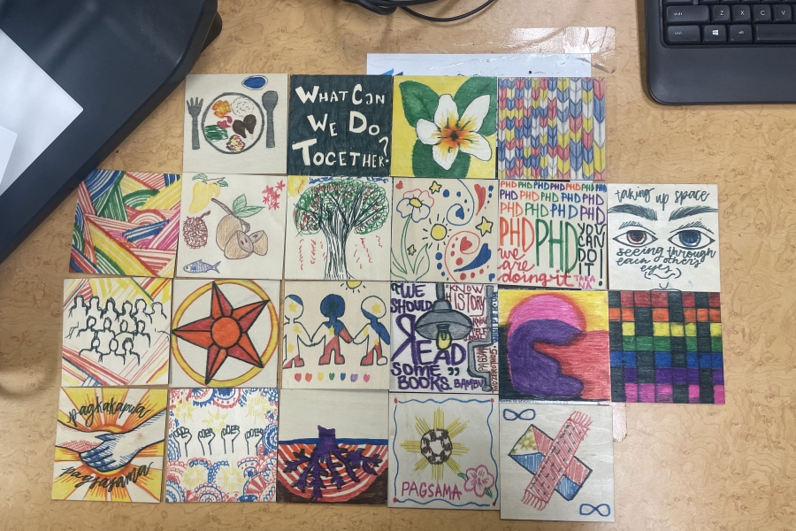 members art pieces connected together in a grid on a desk
