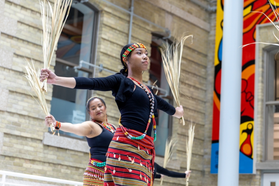 Two dancers wearing traditional Filipino clothing. 