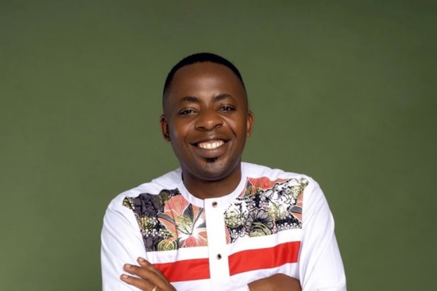 Franck Ghomsi posing against a green backdrop.