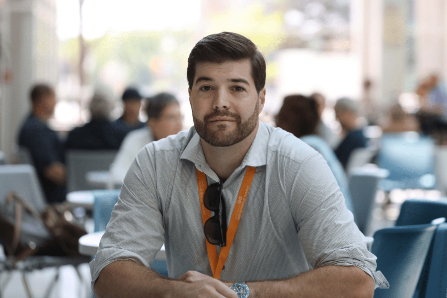 Man sits in a large room.