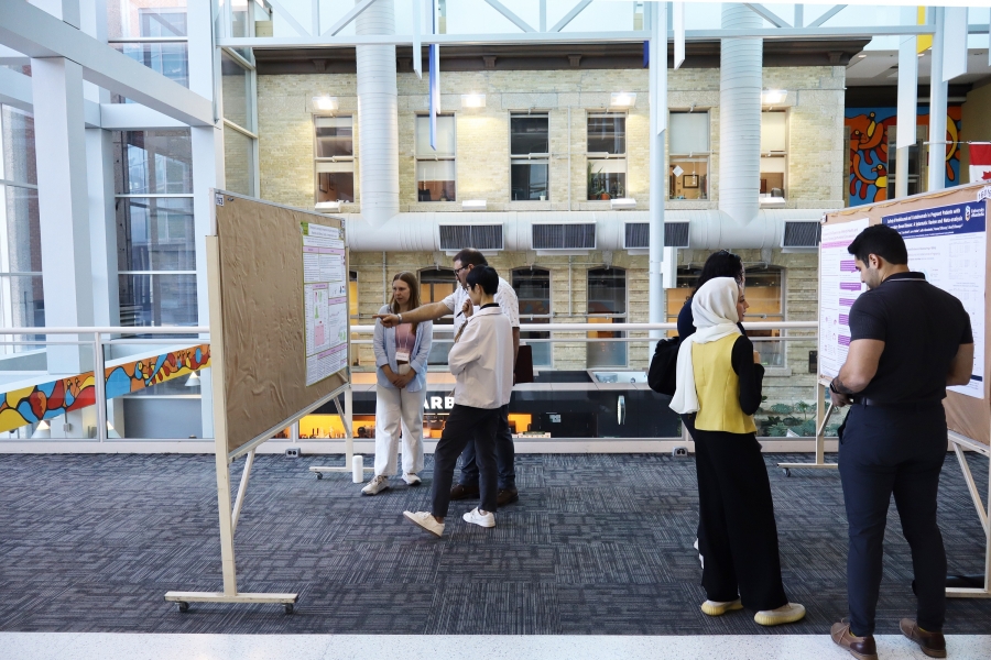 Students presenting research posters in Brodie atrium at Bannatyne campus.