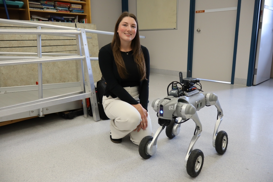 Brooke Peterson poses with a robot dog.