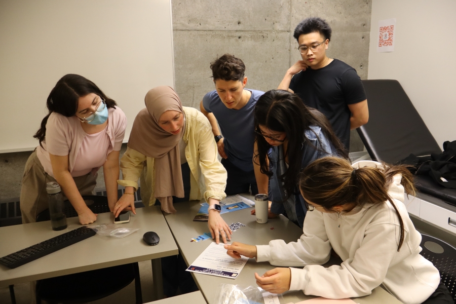 A group of students working together around a table.