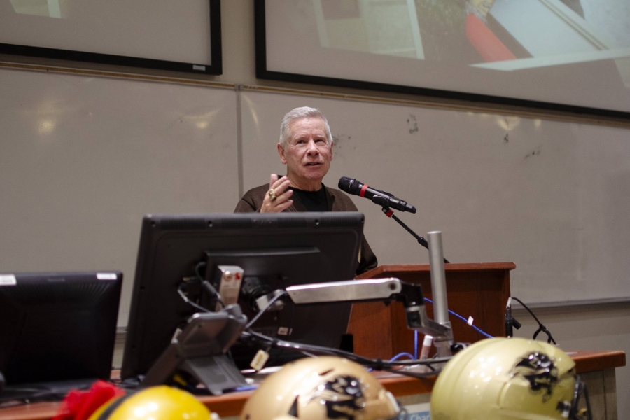 Brian Dobie speaking in front of a podium and microphone