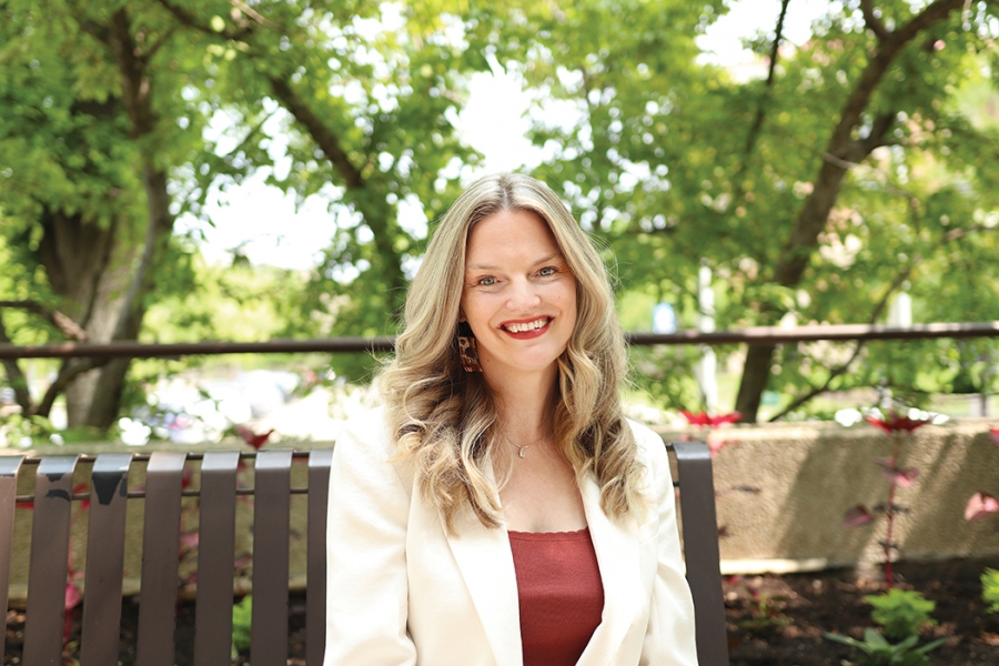 Marnie Kraker sits outside at Fort Garry campus.