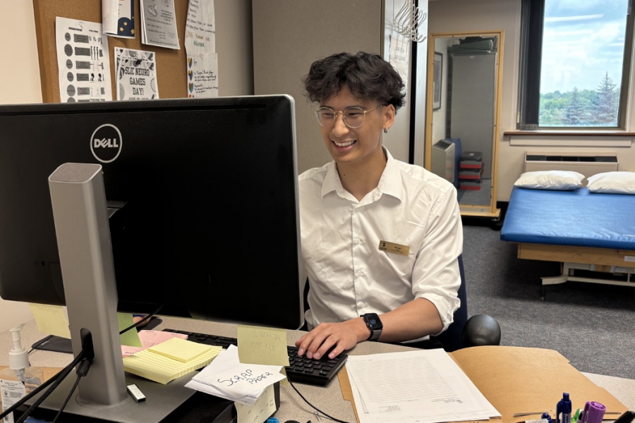 Michael Li works at a computer at the Student-Led Interprofessional Neuro Clinic at Riverview Health Centre.