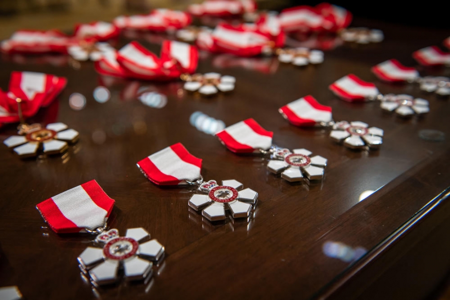Order of Canada pins laying on a table