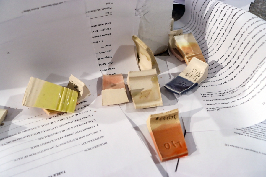 Small ceramic test pieces arranged on printed text pages