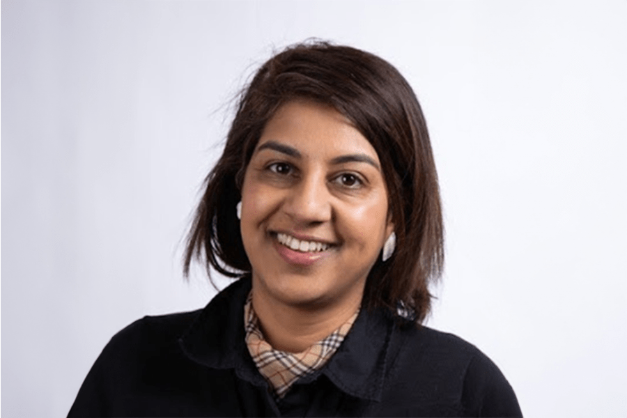 Dr. Punam Mehta smiling in front of a white background