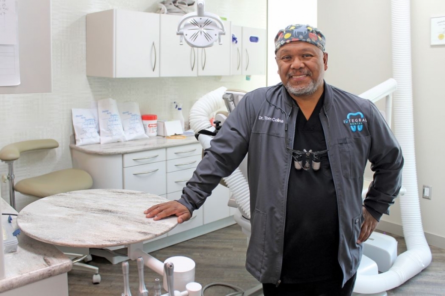 Dr. Tom Colina stands in a dental operatory. 