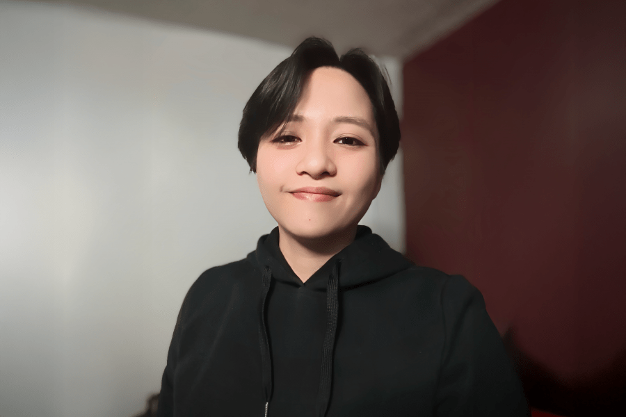 Student with short dark hair smiling for a picture