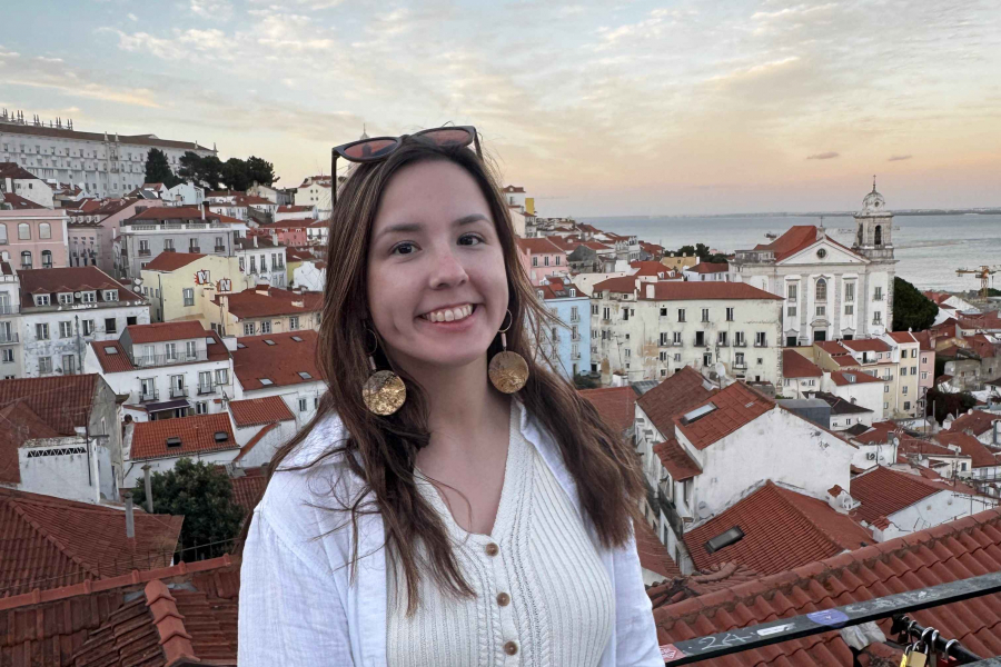 Female smiles for portrait with sunset background. 