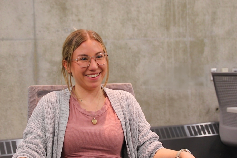 Rebecca Franklin sitting on a chair in a classroom smiling