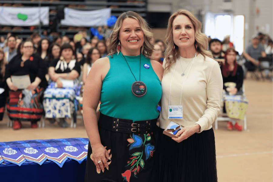 Student Tammy Nelson standing with Migizii Award winner Dr. Kendra Nixon