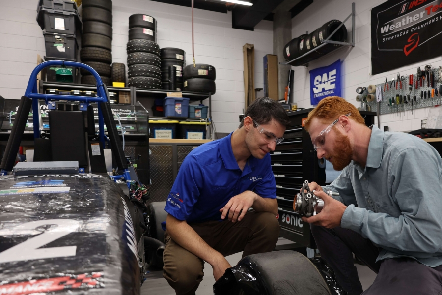 Students working on the UM formula one competition vehicle