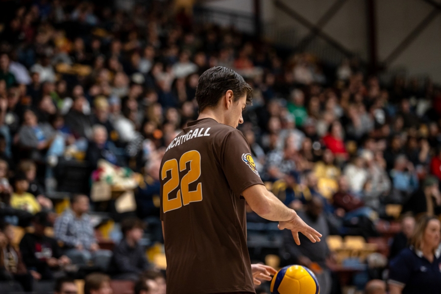 Tyson Nachtigall preparing to serve in front of a large crowd