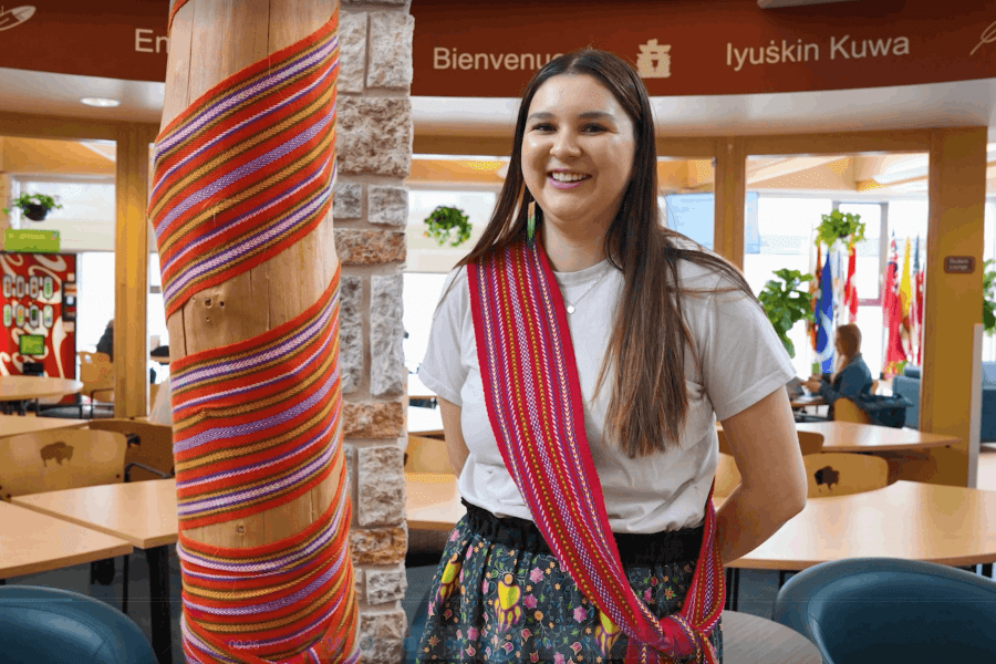 female posing with a smile inside the Indigenous student center at UM.