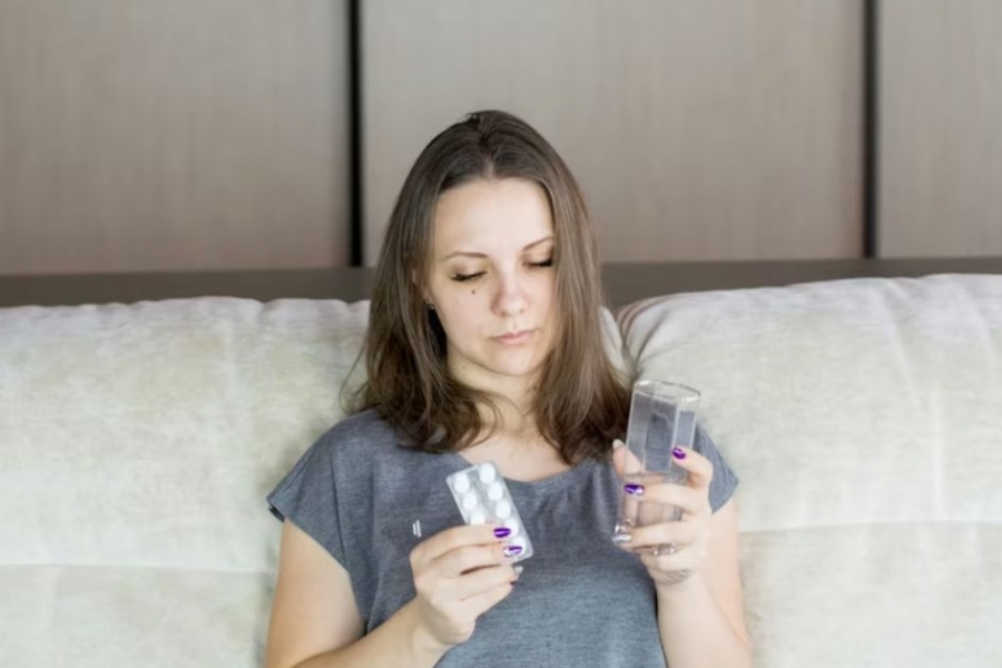 Woman holding a pill pack