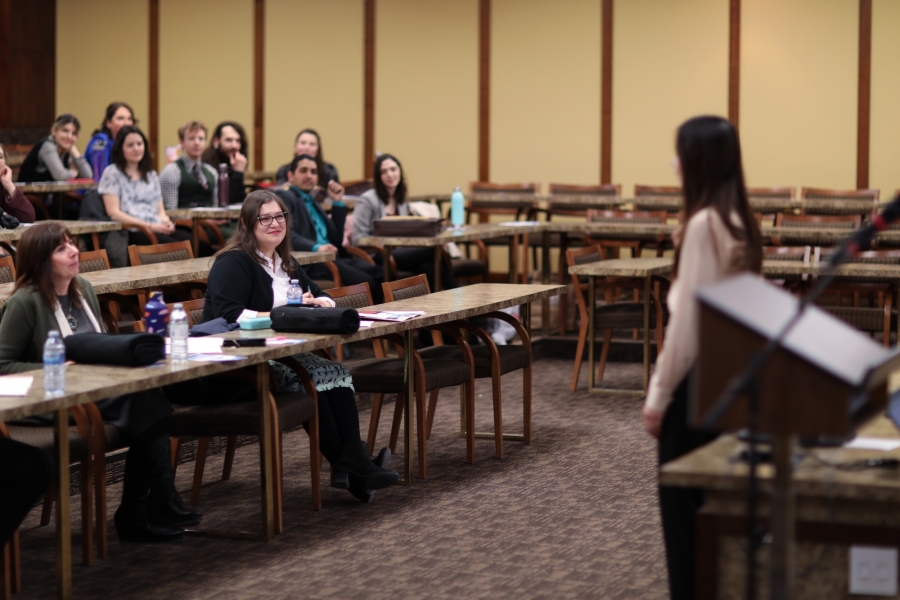 Student presents to a room full of people