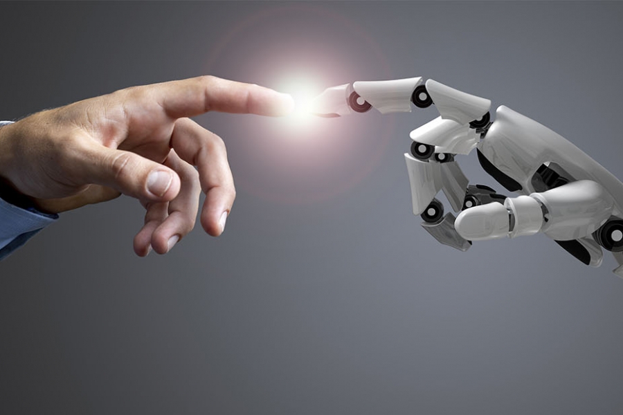 Human hand and robotic hand reaching toward each other with fingertips almost touching.