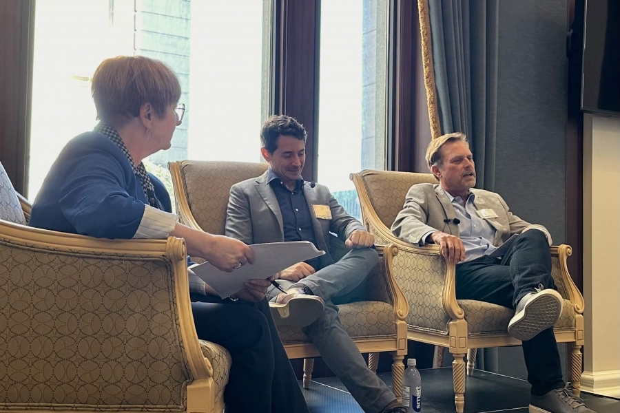 Three speakers sit in armchairs at the Asper After Five event.