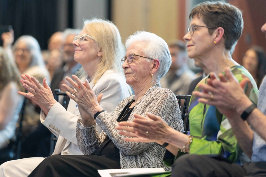 Close up on people applauding and an award event.