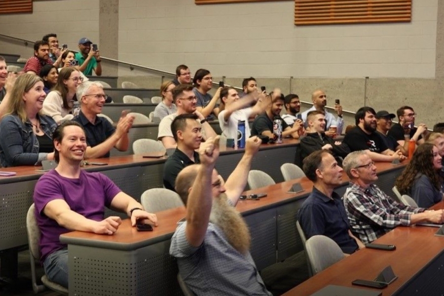 UM Students and faculty cheering while watching the launch in a lecture theatre on campus.