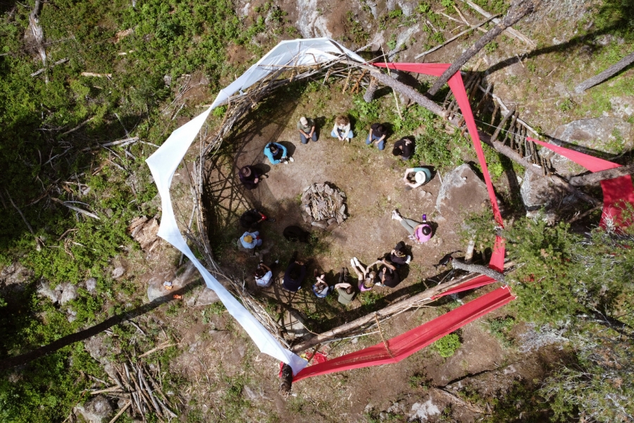 people gathered outside taking part in the forest school