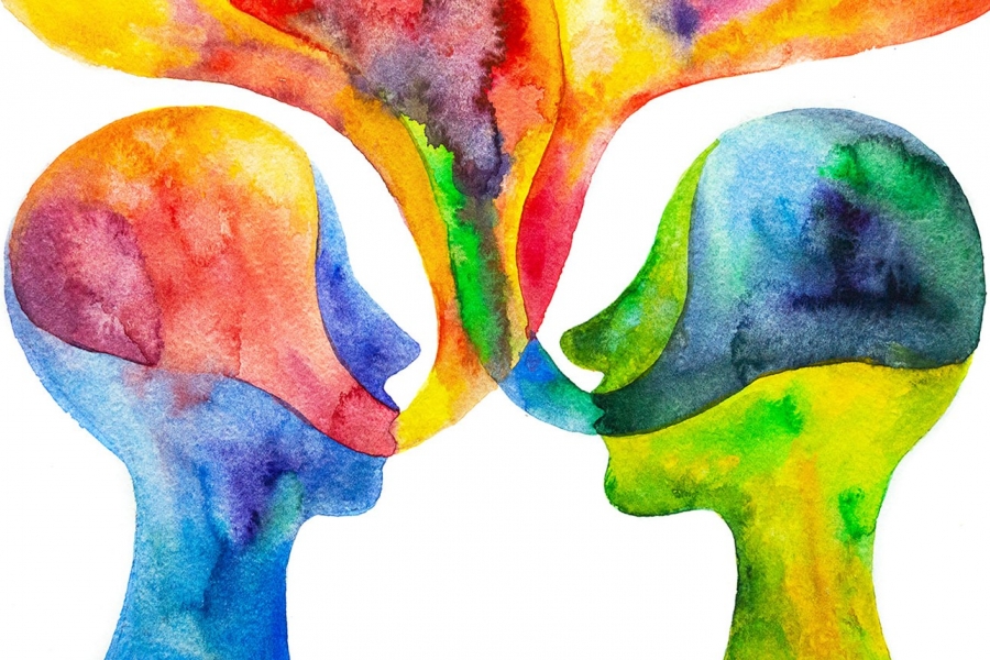 Watercolour painting of two heads facing each other with flowing language bubbles coming out of their mouths. Colours include blues, yellows, oranges, and reds.