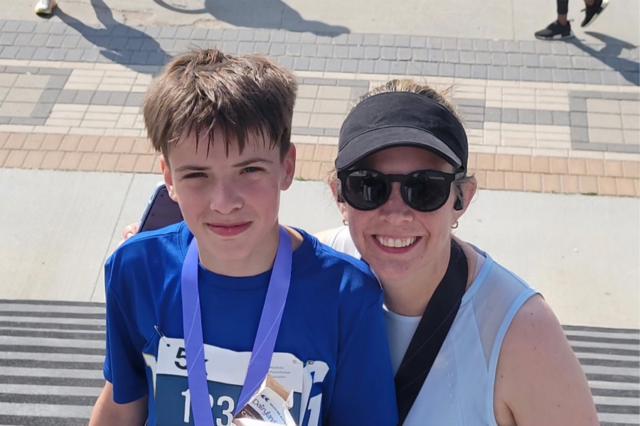 Dr. Shaelyn Strachan smiling with her son after a race