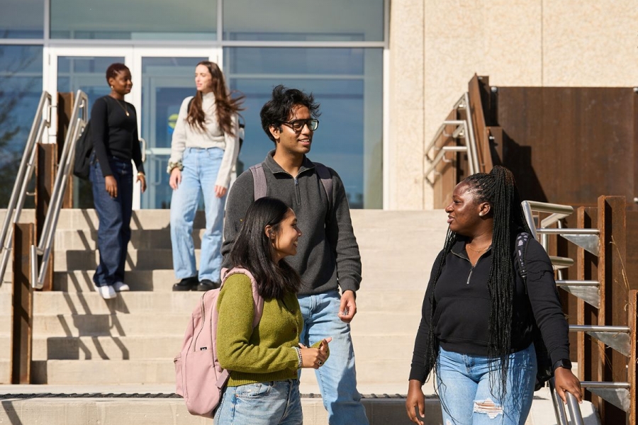 students standing on stairs outside