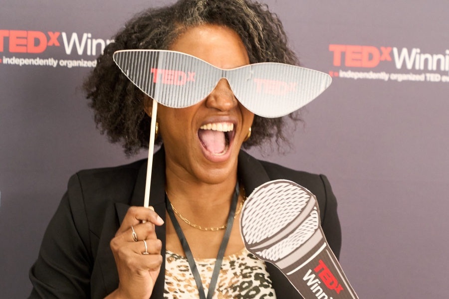 An excited attendee poses with TEDx props