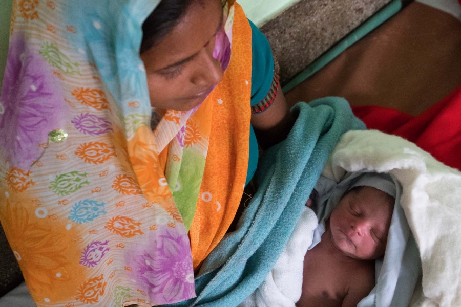 A woman holds a baby.