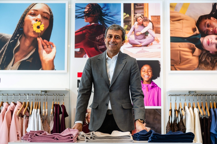 A man looking at the camera with ads behind him
