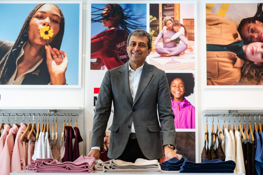 A man looking at the camera with ads behind him