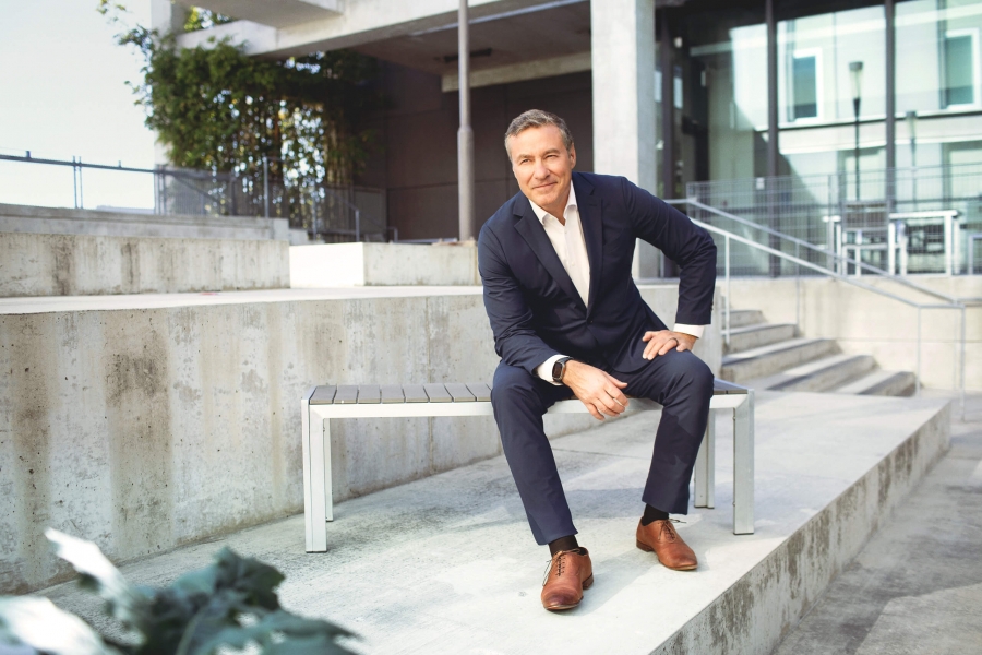 A man in a suit sits on a bench 