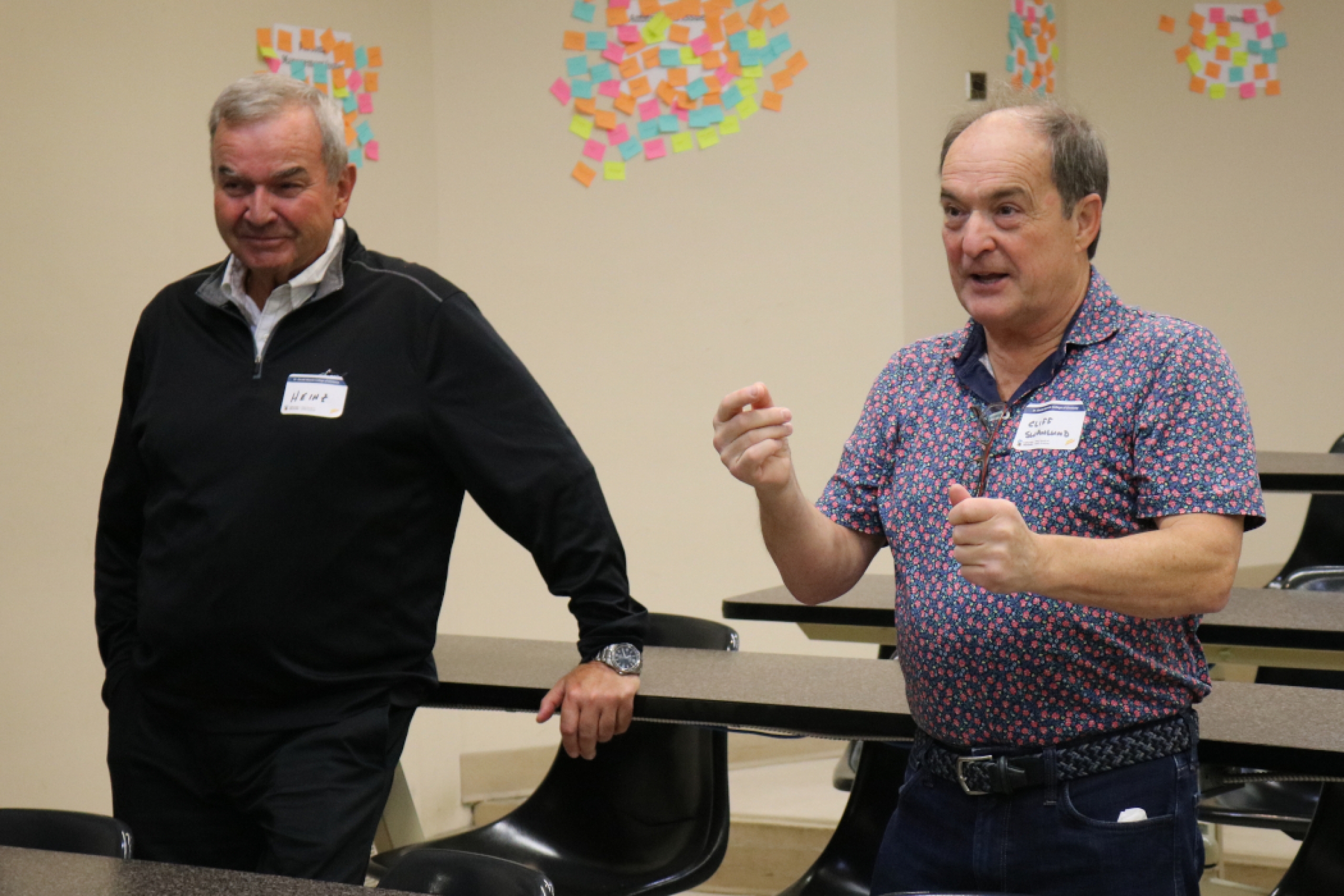 Two dentistry alumni, one is talking in a classroom. 