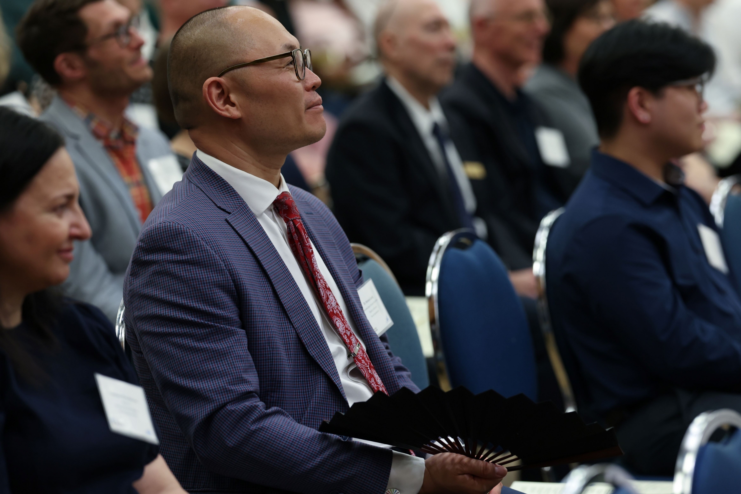 An audience member is watching from the crowd.