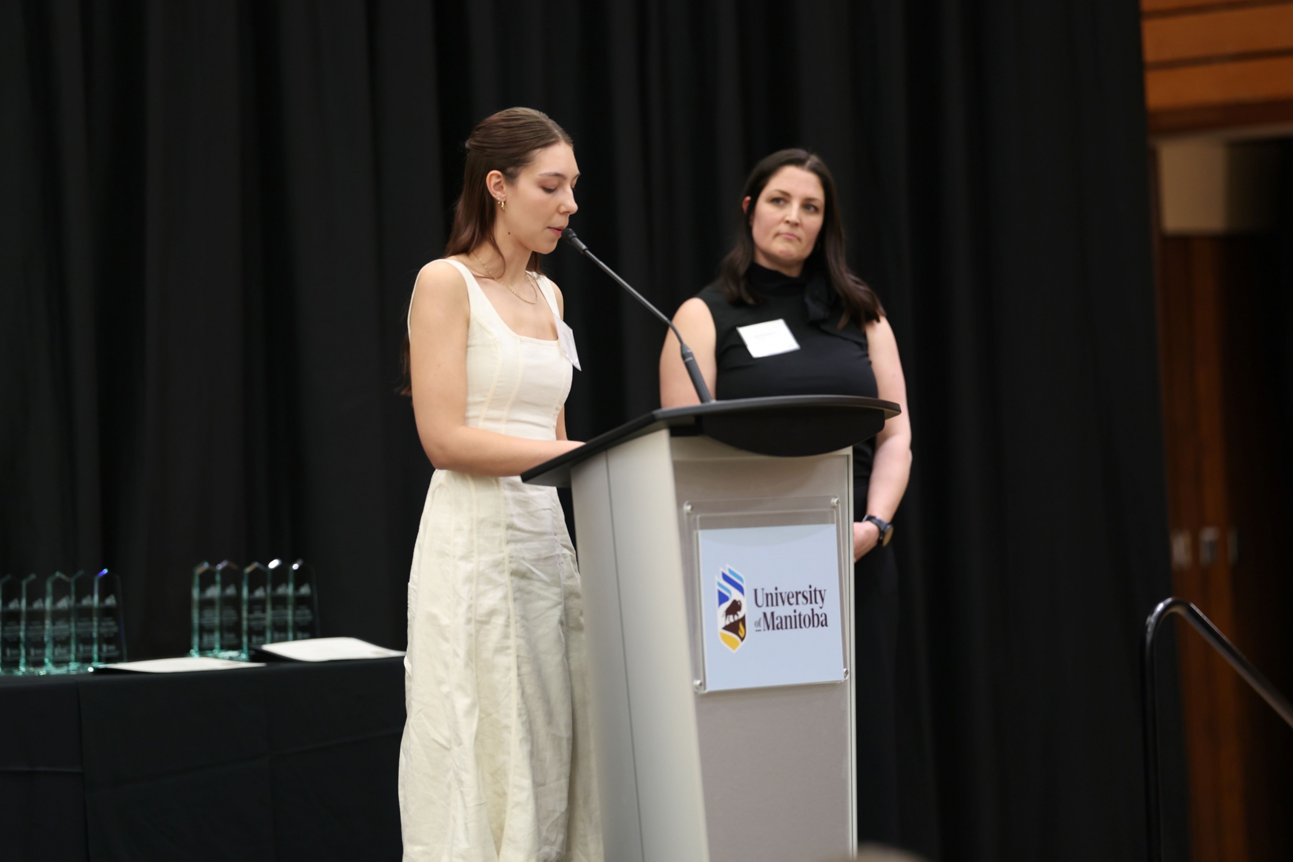 A graduating student is giving her speech.