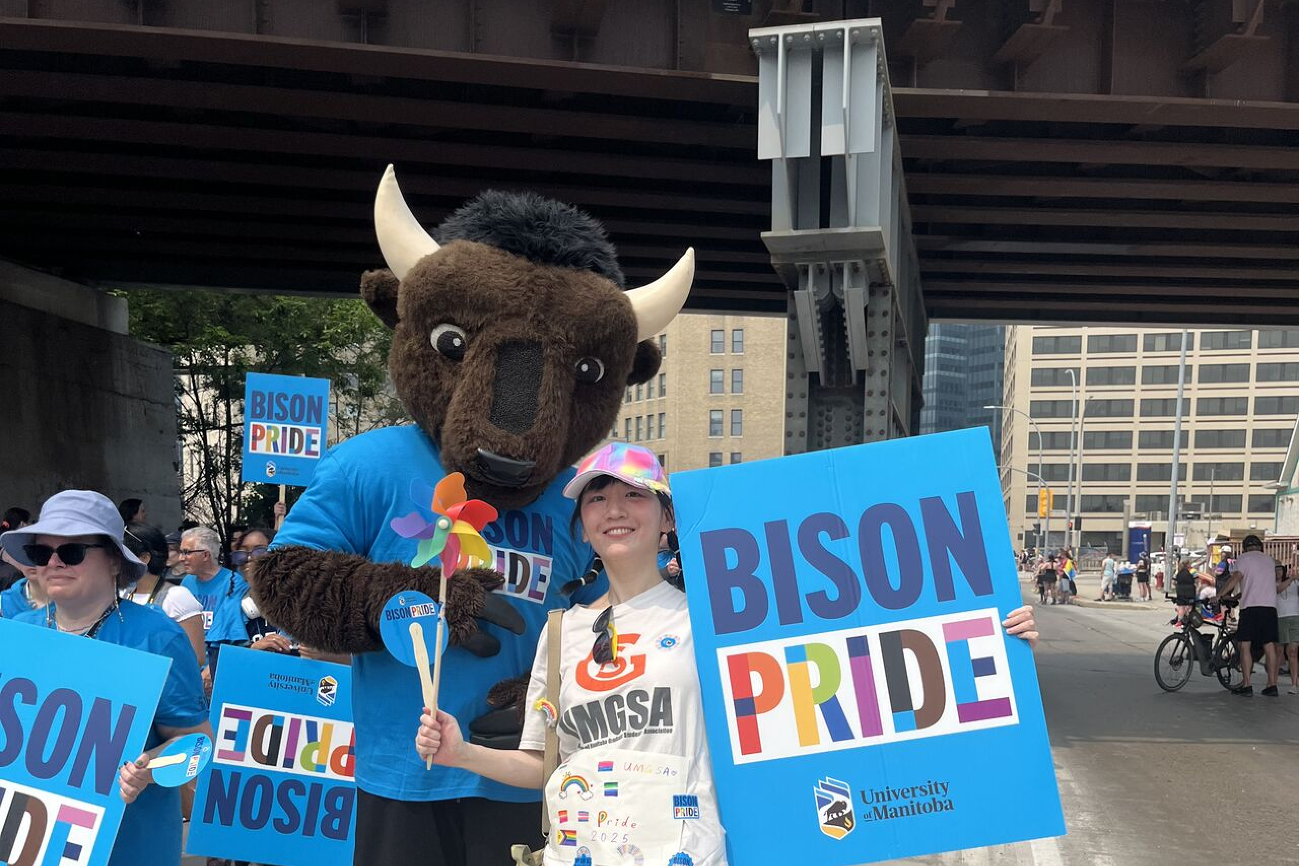 Peggy Wu and tall Billy at the Winnipeg pride parade