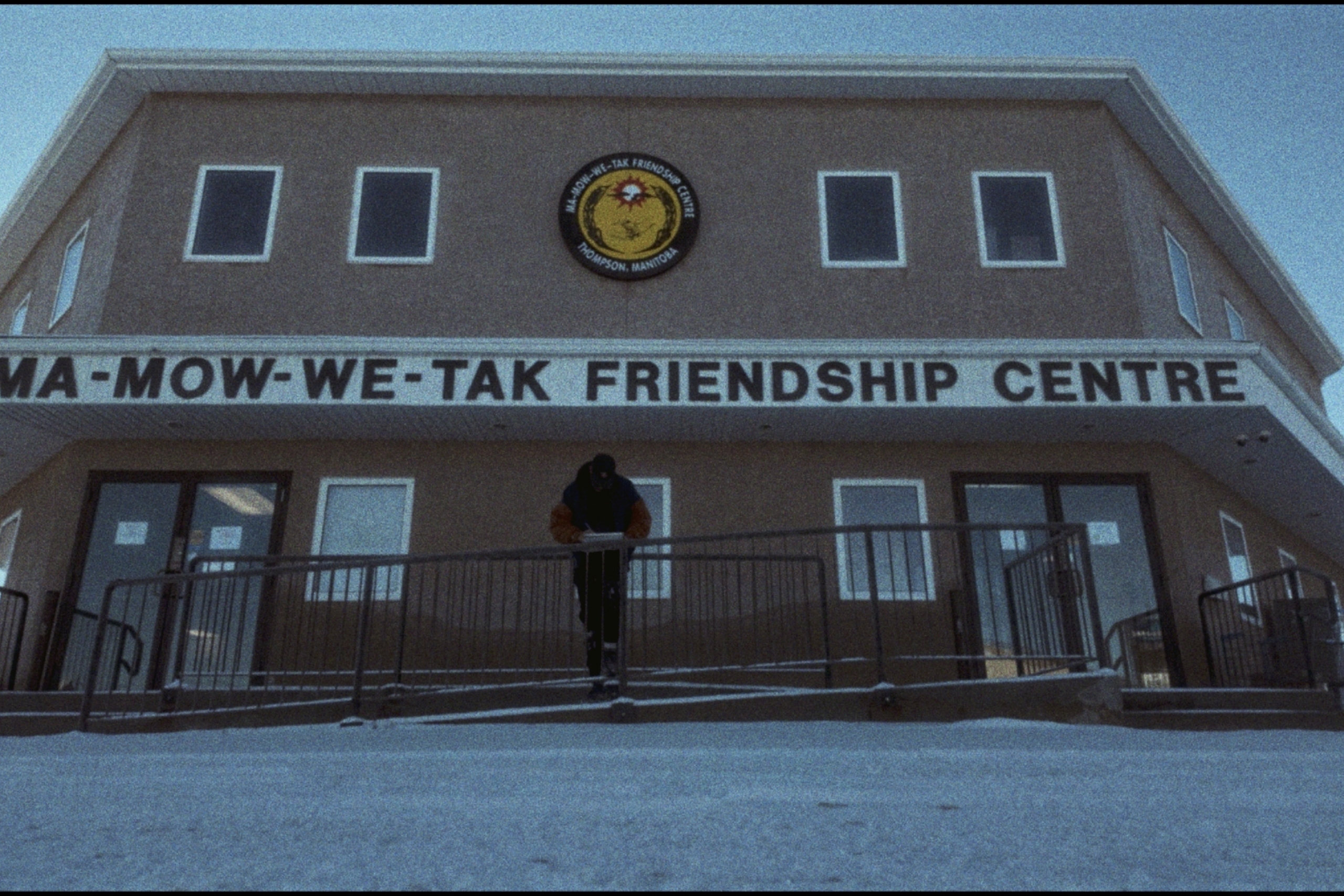 Thompson Friendship Centre is a big beige building with a large sign ma mow we tak friendship centre.