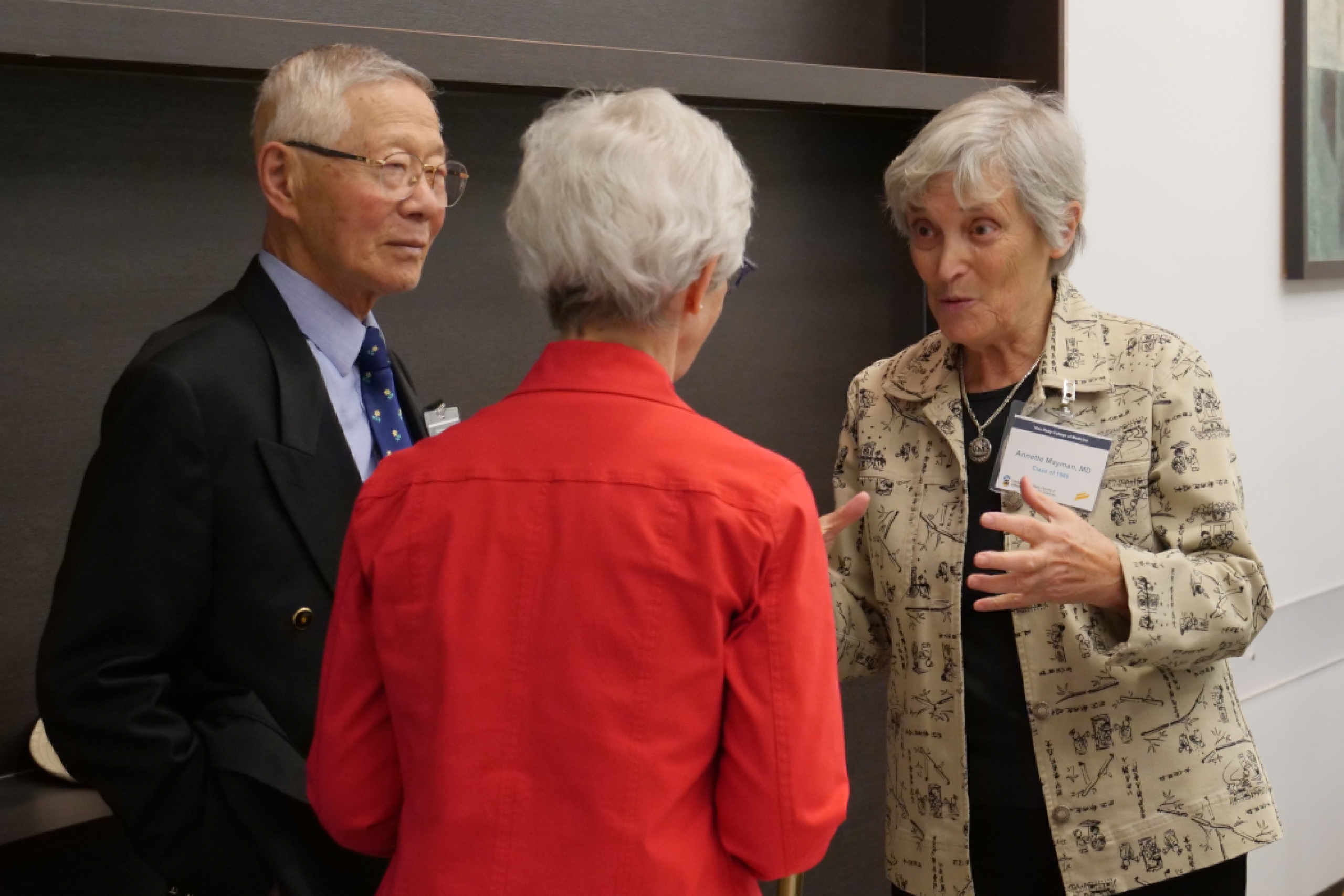 Three medicine alumni have a conversation. 