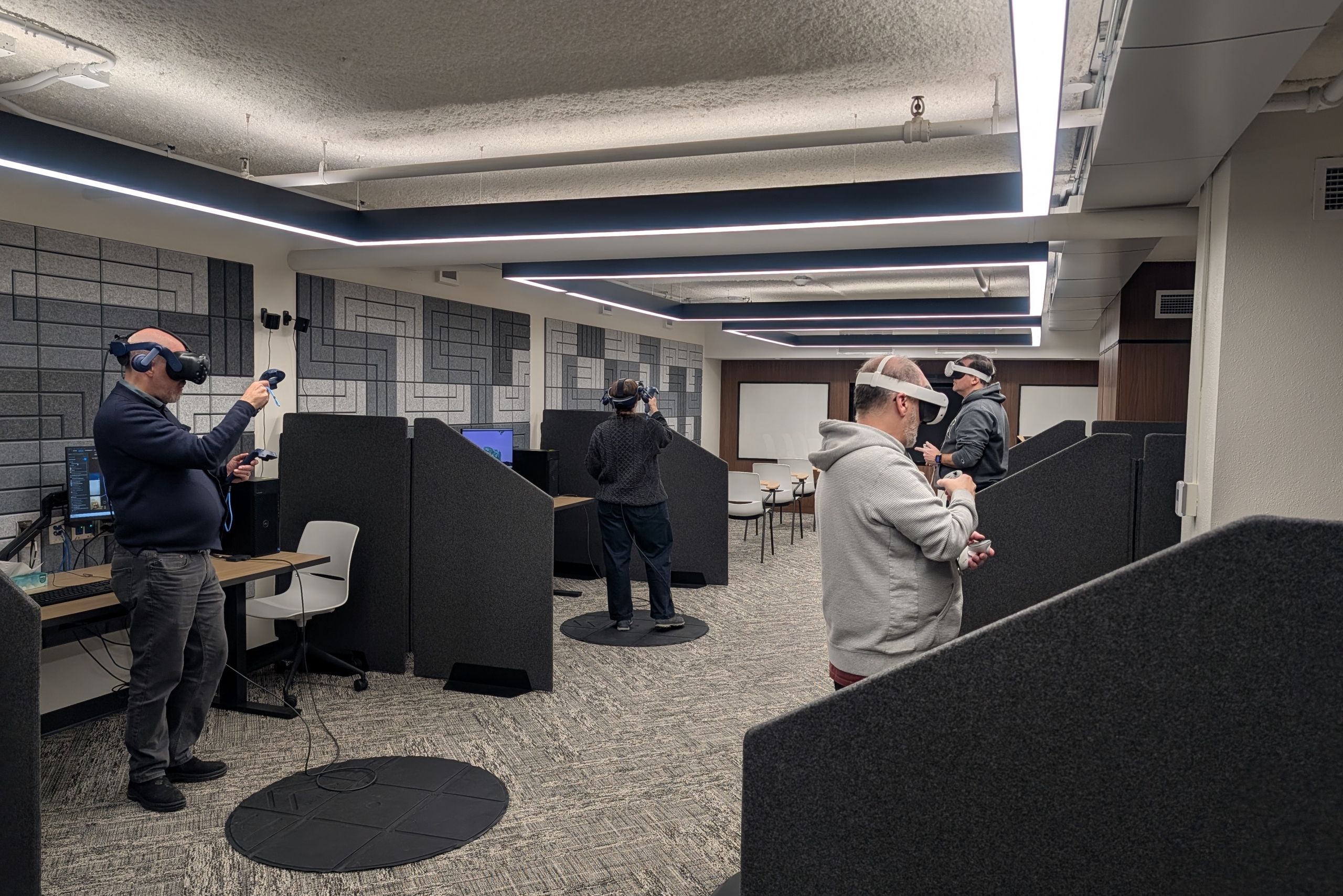 Faculty using VR stations in XR Lab