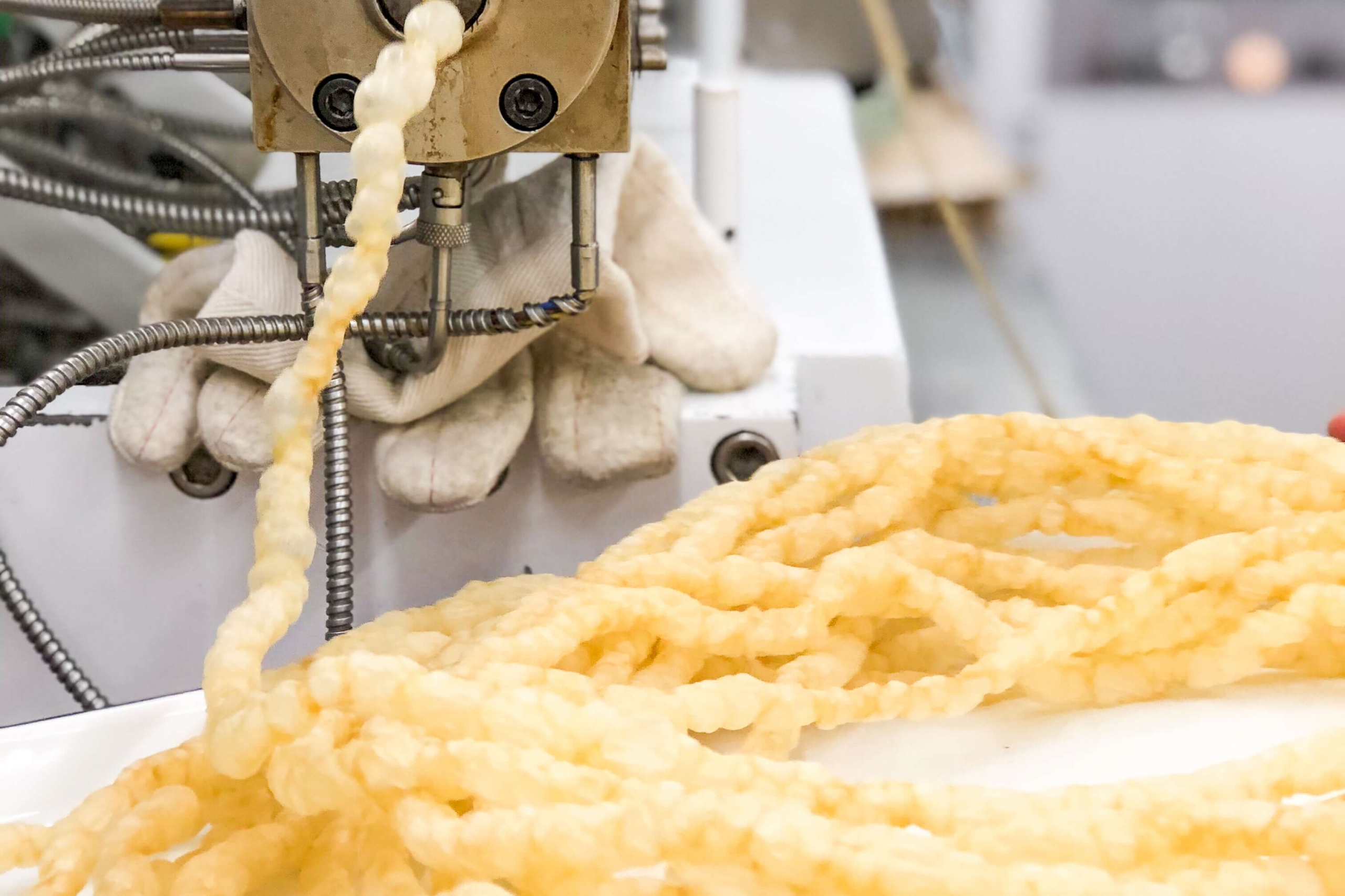 A food product comes out of a machine