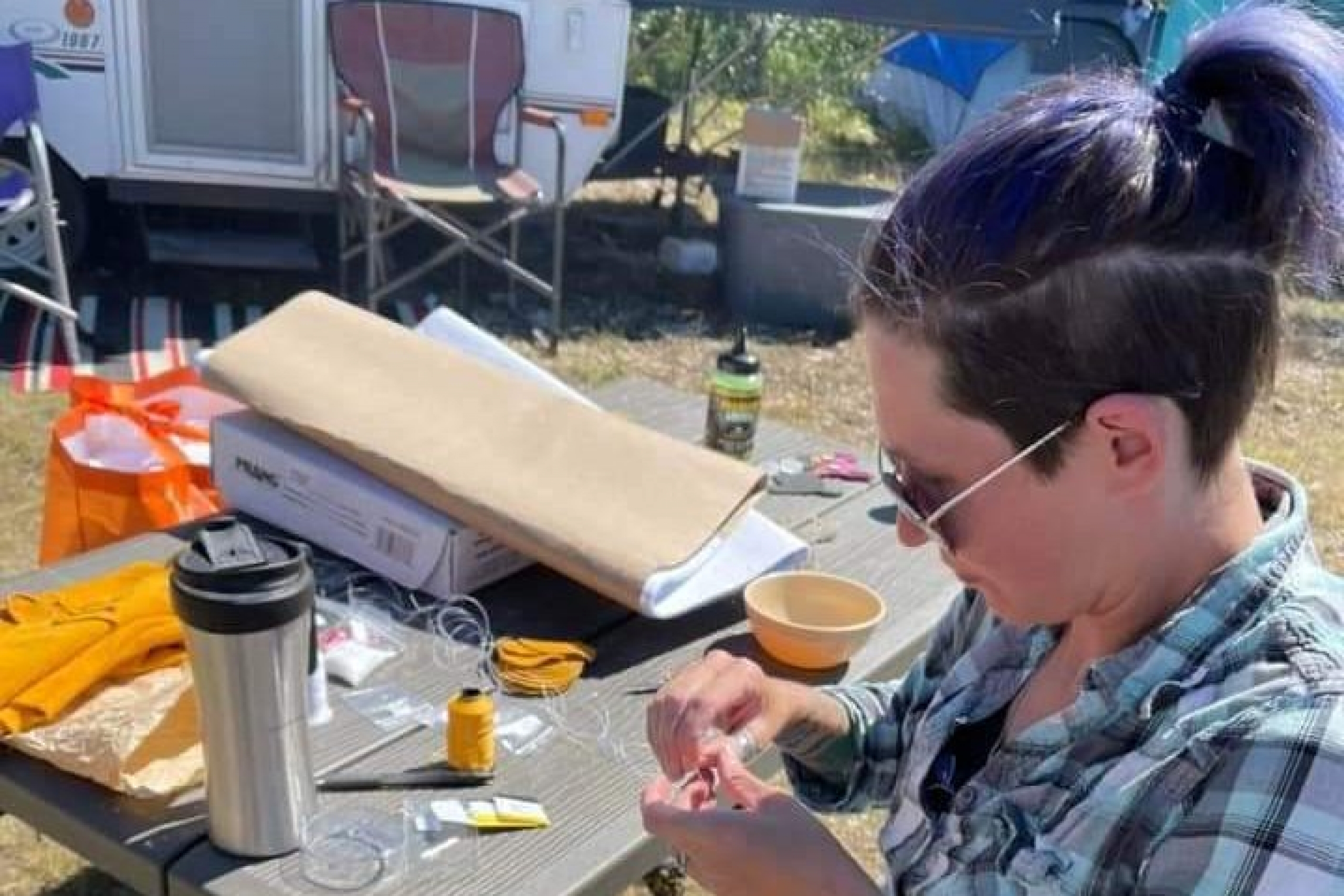 A person is seated outside.