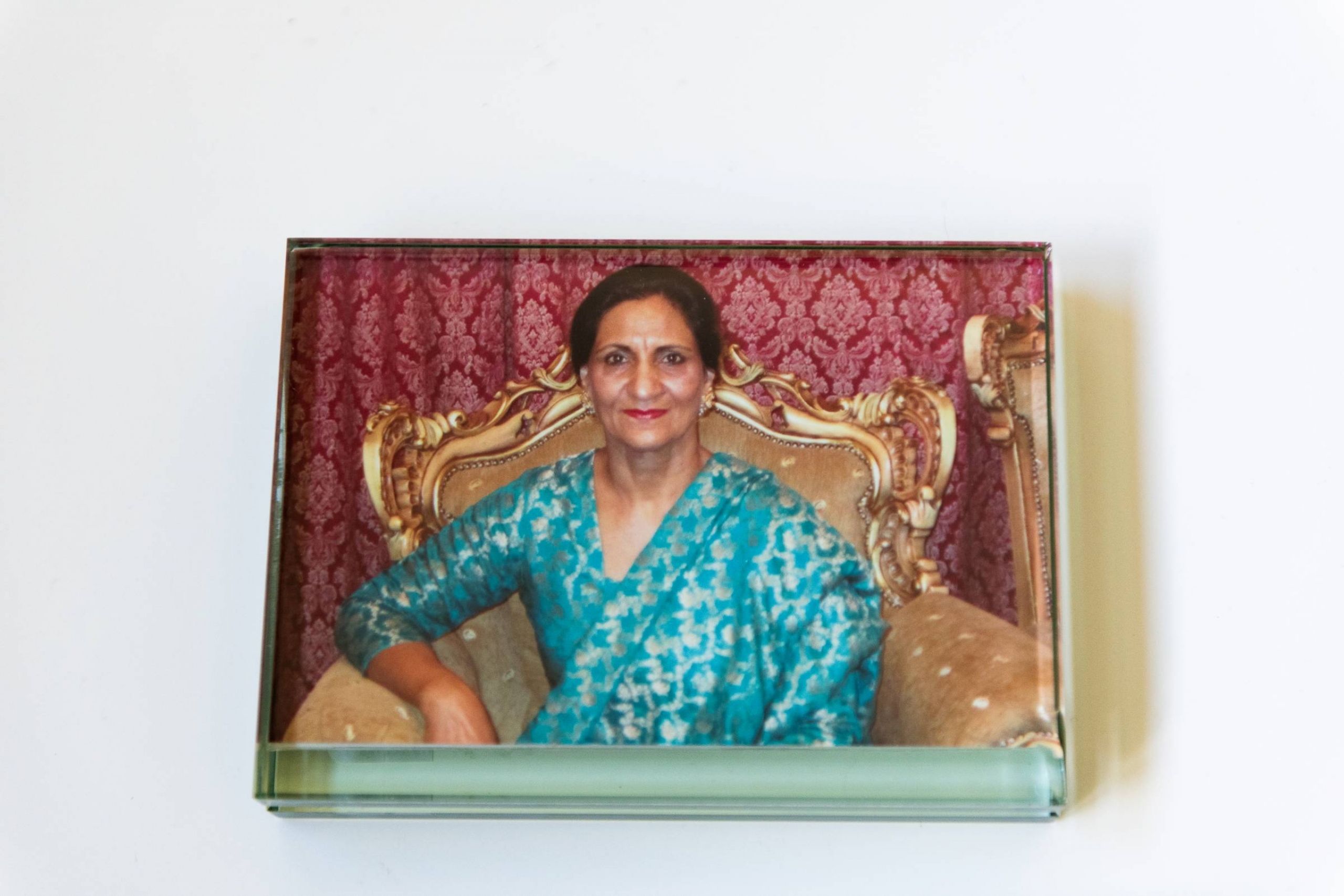 A photograph of Huma Sharif's mother, sitting in an ornate chair